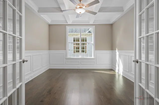 a large kitchen with stainless steel appliances a large counter top a stove and a wooden floors