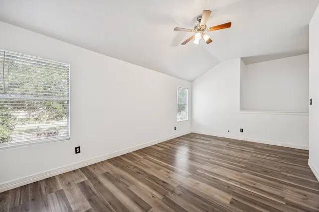 wooden floor in an empty room with a window
