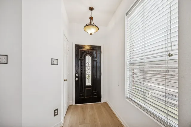 a view of a hallway with wooden floor and staircase