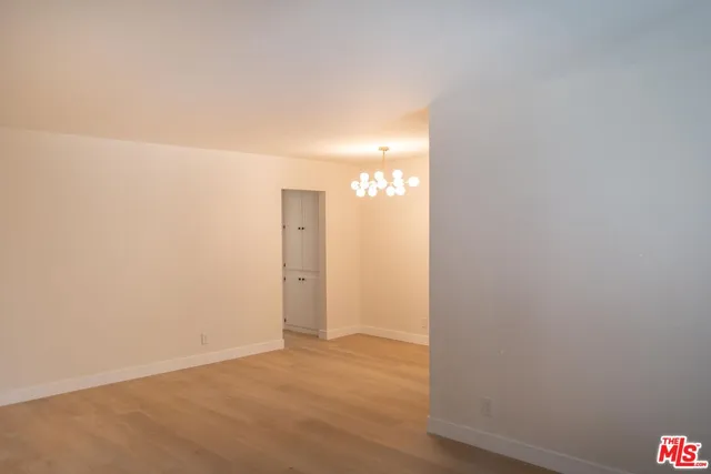 an empty room with a kitchen and a window