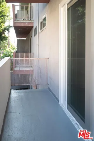 a front view of a building with a garden