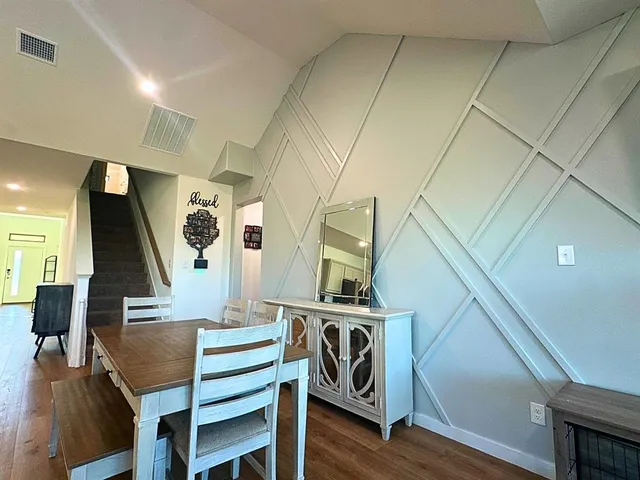 a view of a livingroom with furniture and staircase