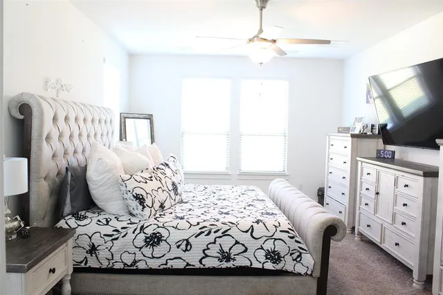 a bedroom with furniture and a flat screen tv