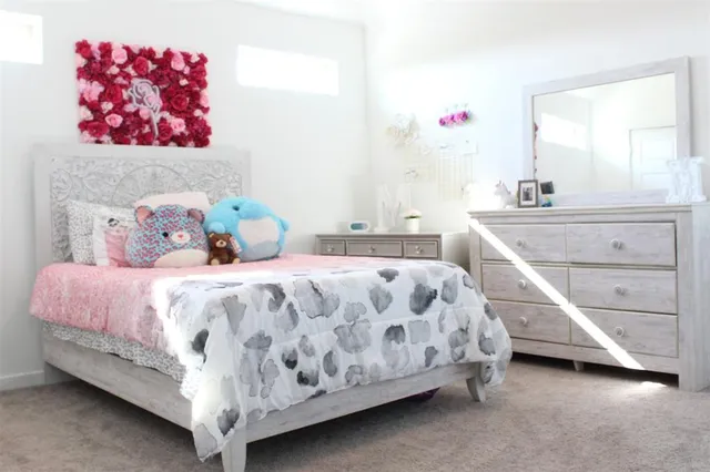 a bedroom with a bed and a mirror