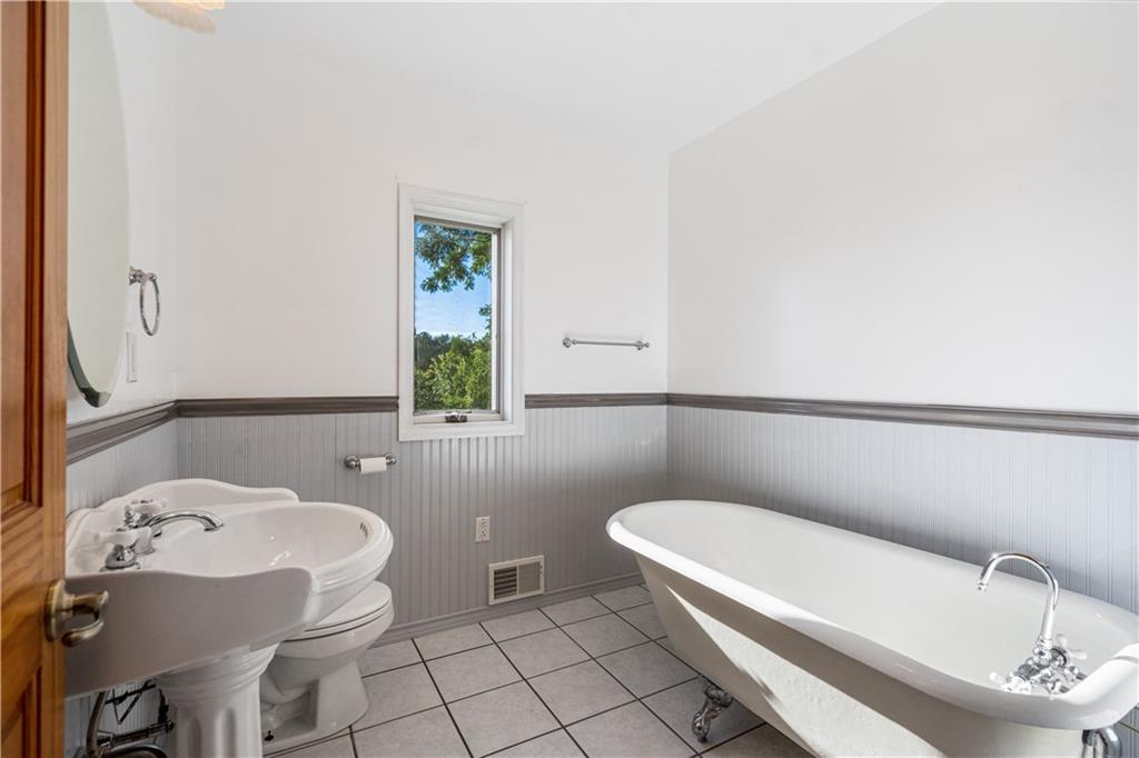58 Happy Valley Road Perryopolis, PA 15473 - Photo 10 of 25 a bathroom with a sink a toilet and a mirror