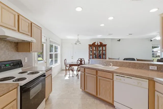 a kitchen with a stove and a white cabinets