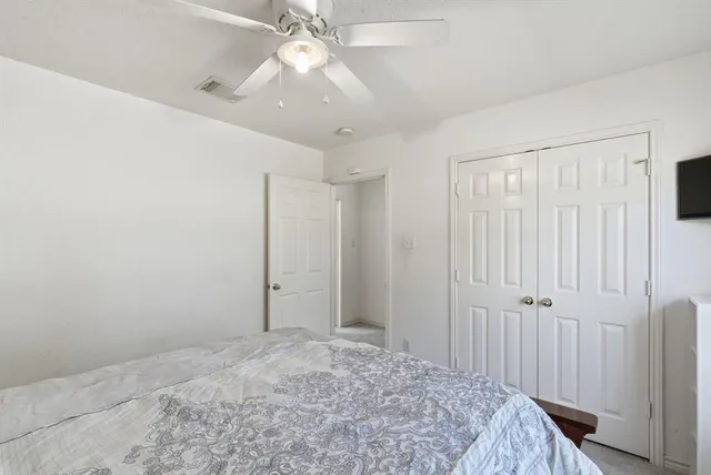 a view of a livingroom with a chandelier fan