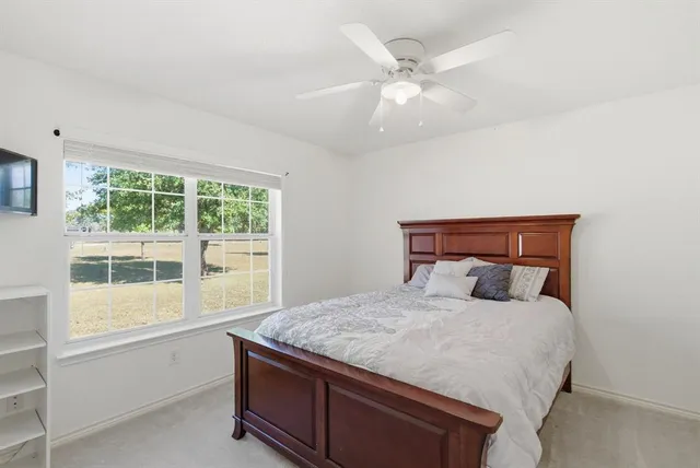 a bedroom with a large bed and a large window