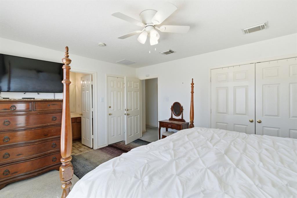 2710 Fairview Road Millsap, TX 76066 - Photo 17 of 40 a bedroom with a bed and a flat screen tv