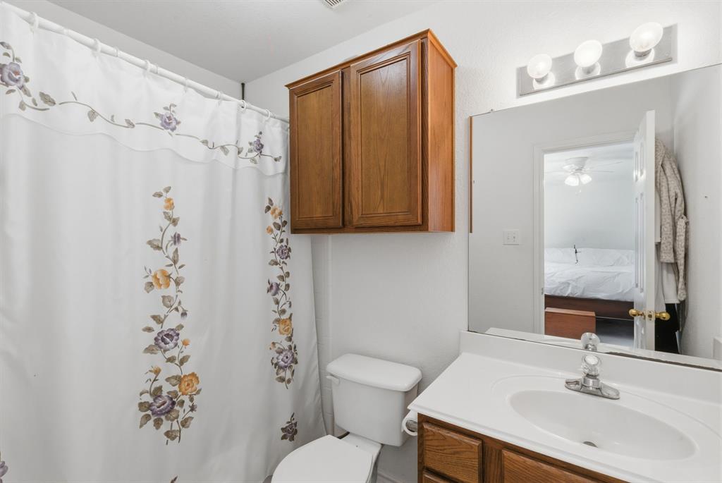 2710 Fairview Road Millsap, TX 76066 - Photo 18 of 40 a bathroom with a sink toilet and shower