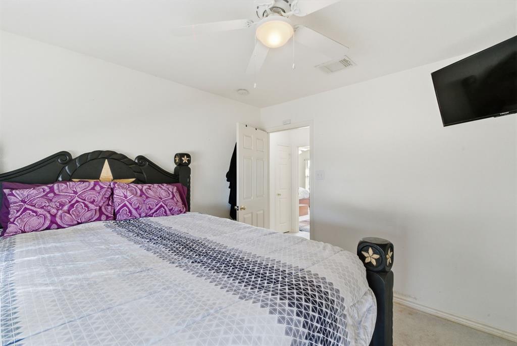 2710 Fairview Road Millsap, TX 76066 - Photo 20 of 40 a bedroom with a bed and a flat screen tv