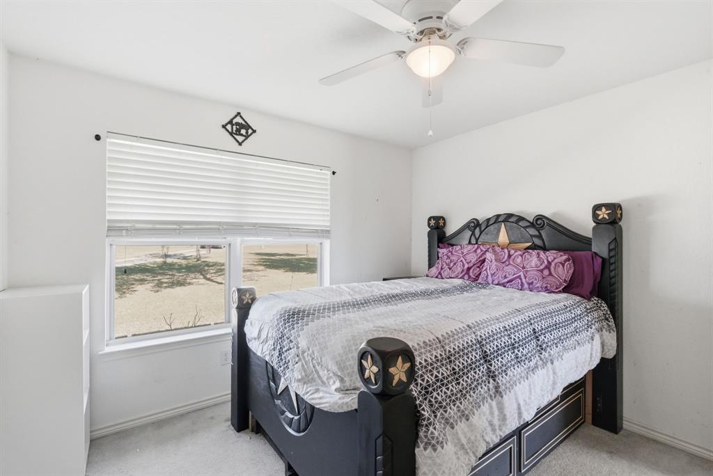 2710 Fairview Road Millsap, TX 76066 - Photo 21 of 40 a bedroom with a bed and a window