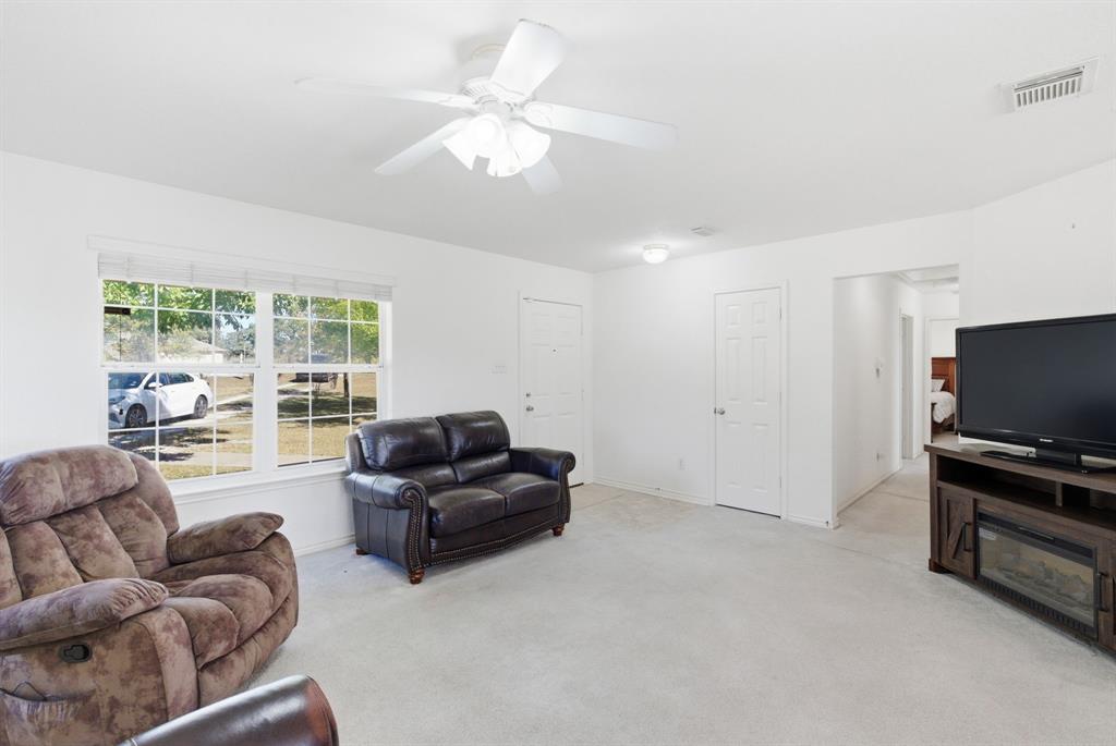 2710 Fairview Road Millsap, TX 76066 - Photo 6 of 40 a living room with furniture and a flat screen tv