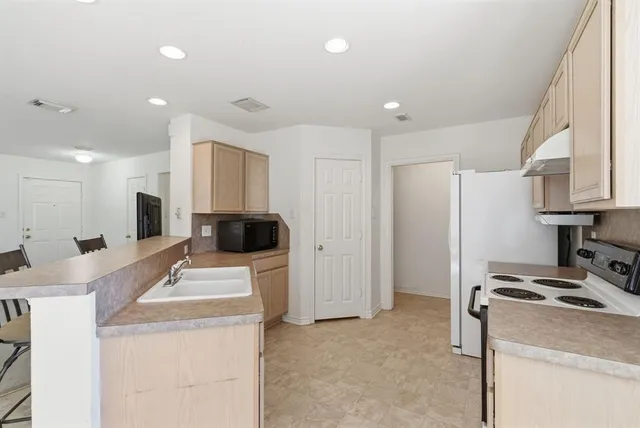 a room with a sink a washer and dryer