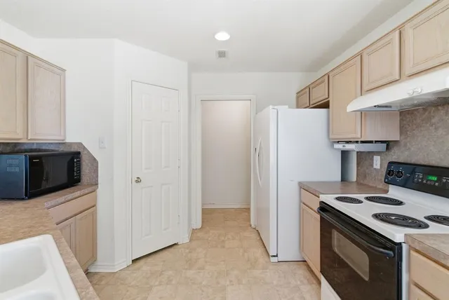 a kitchen with a stove and a microwave