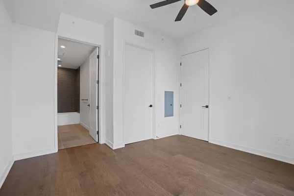a view of empty room with wooden floor