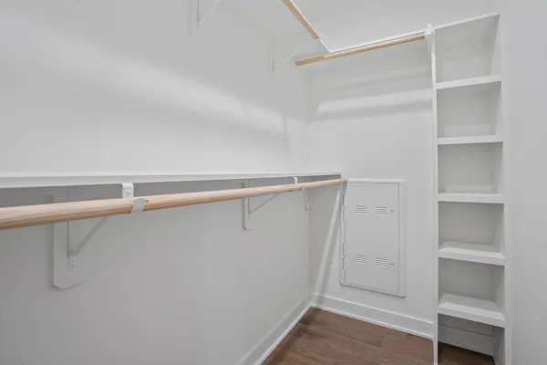 a view of walk in closet with empty racks