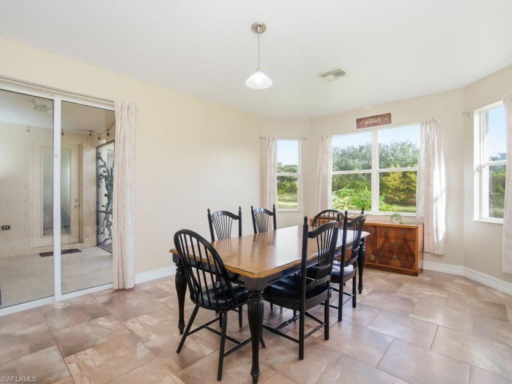 12719 Stone Tower Loop Fort Myers, FL 33913 - Photo 11 of 45 a view of a dining room with furniture window and outside view