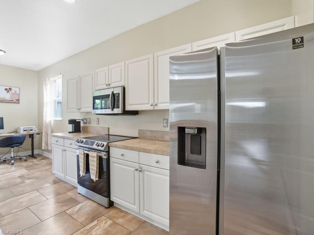 12719 Stone Tower Loop Fort Myers, FL 33913 - Photo 19 of 45 a kitchen with stainless steel appliances granite countertop a refrigerator a stove and a sink