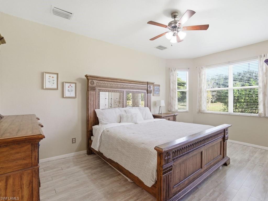 12719 Stone Tower Loop Fort Myers, FL 33913 - Photo 20 of 45 a bed sitting in a bedroom next to a window
