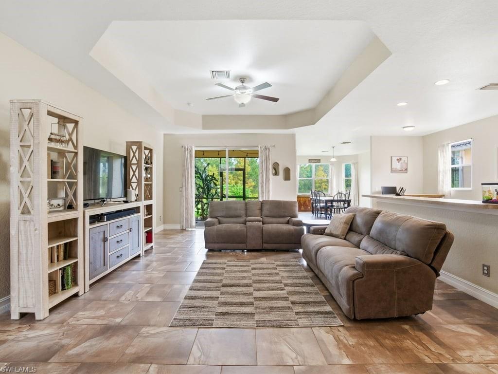 12719 Stone Tower Loop Fort Myers, FL 33913 - Photo 2 of 45 a living room with furniture and a large window