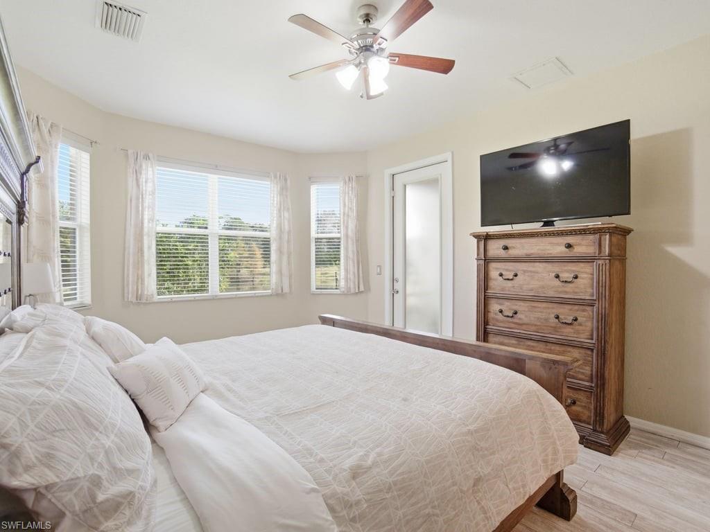 12719 Stone Tower Loop Fort Myers, FL 33913 - Photo 22 of 45 a bedroom with a bed and a flat screen tv