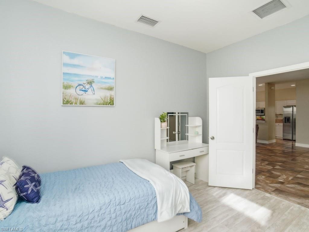 12719 Stone Tower Loop Fort Myers, FL 33913 - Photo 29 of 45 a bedroom with a bed and a cabinets