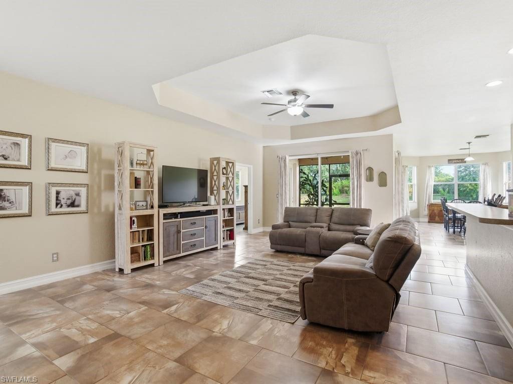 12719 Stone Tower Loop Fort Myers, FL 33913 - Photo 3 of 45 a living room with furniture and a flat screen tv