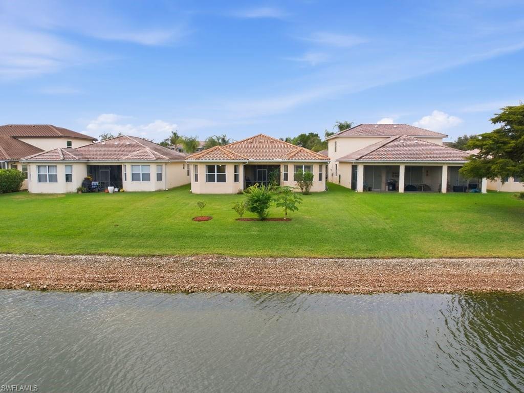 12719 Stone Tower Loop Fort Myers, FL 33913 - Photo 33 of 45 a front view of a house with a garden and yard