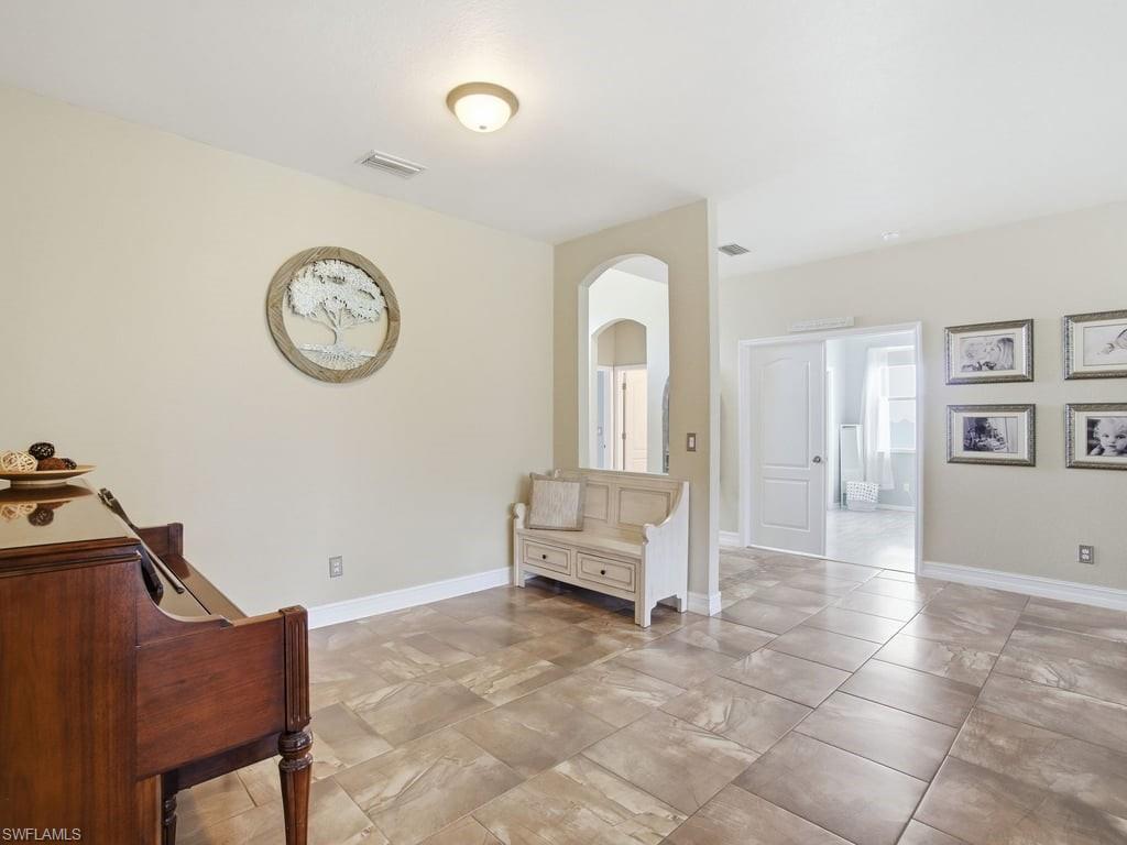 12719 Stone Tower Loop Fort Myers, FL 33913 - Photo 8 of 45 a view of a livingroom with furniture and a ceiling fan