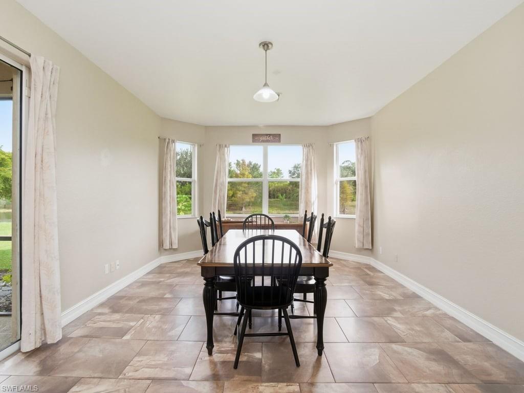 12719 Stone Tower Loop Fort Myers, FL 33913 - Photo 10 of 45 a view of a dining room with furniture window and outside view