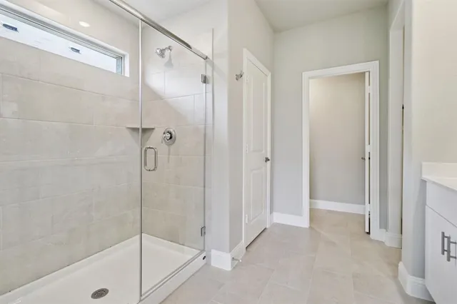 a bathroom that has a glass shower door