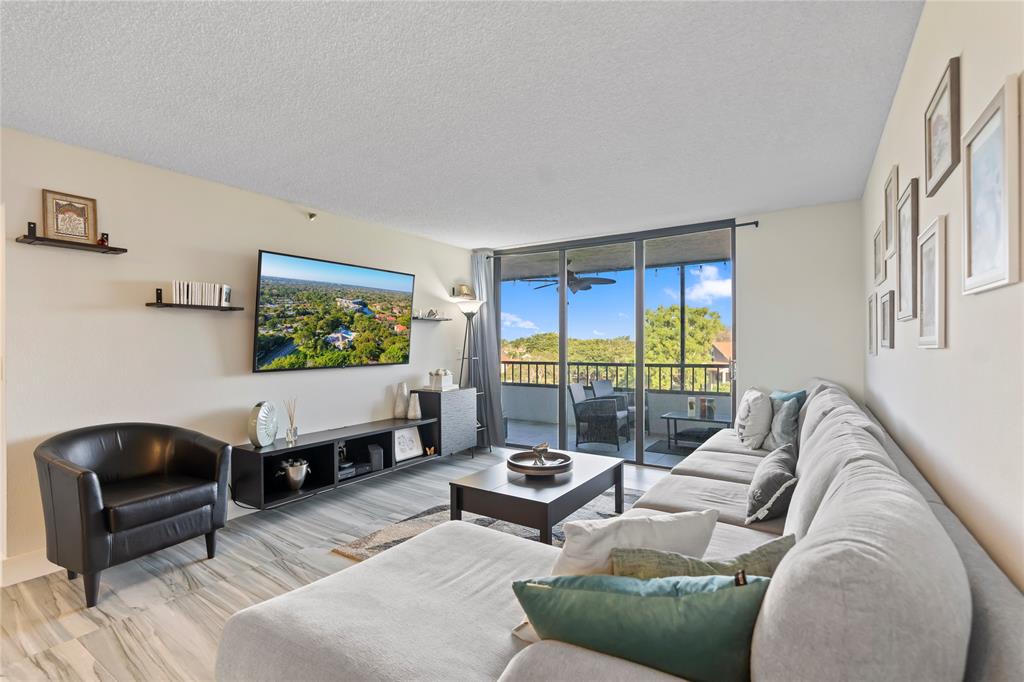 1850 Homewood Boulevard, Unit 512 Delray Beach, FL 33445 - Photo 15 of 43 a living room with furniture and a large window