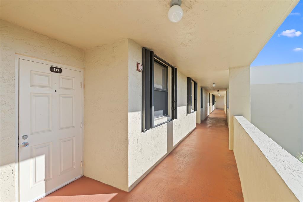 1850 Homewood Boulevard, Unit 512 Delray Beach, FL 33445 - Photo 2 of 43 a hallway with windows