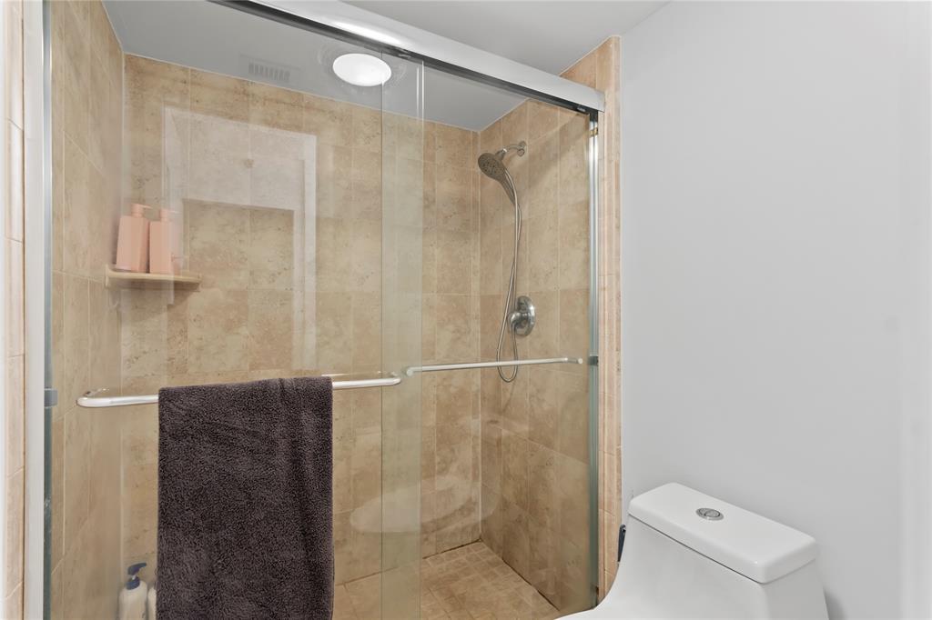 1850 Homewood Boulevard, Unit 512 Delray Beach, FL 33445 - Photo 21 of 43 a bathroom with a shower and a toilet