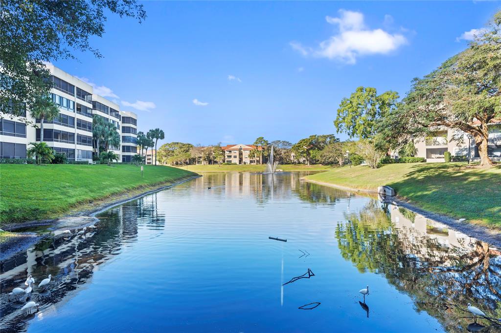 1850 Homewood Boulevard, Unit 512 Delray Beach, FL 33445 - Photo 24 of 43 a view of a lake with a big yard