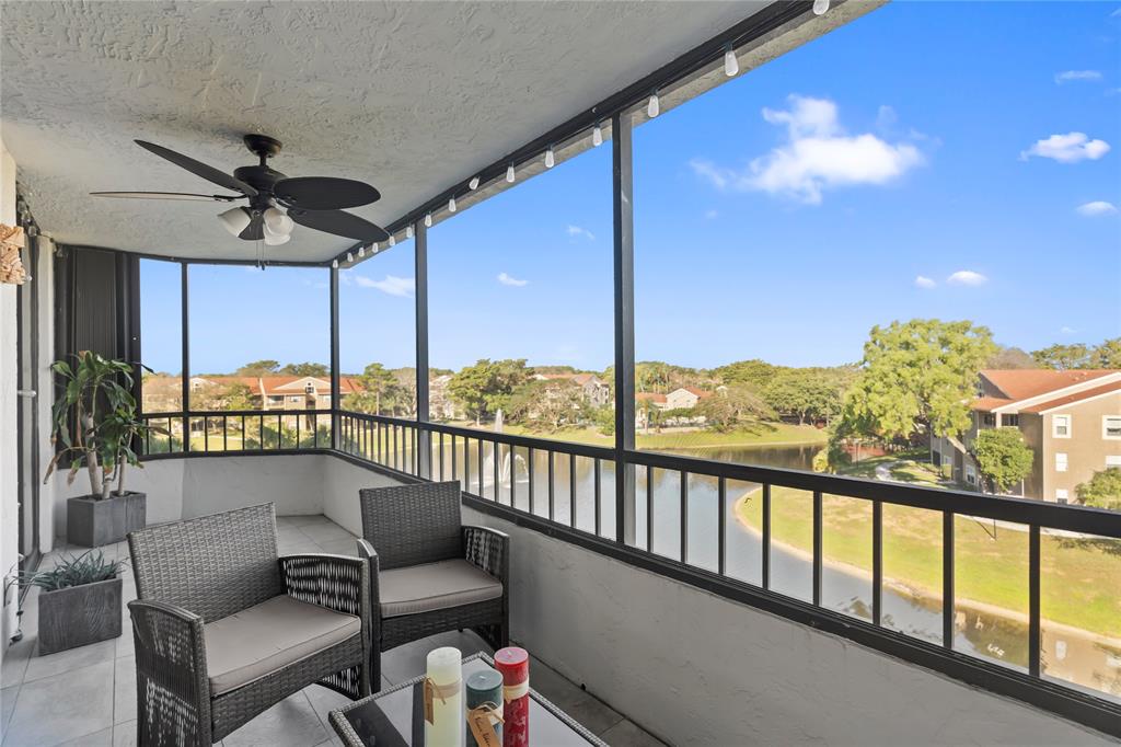 1850 Homewood Boulevard, Unit 512 Delray Beach, FL 33445 - Photo 25 of 43 a balcony with furniture and a view of a lake