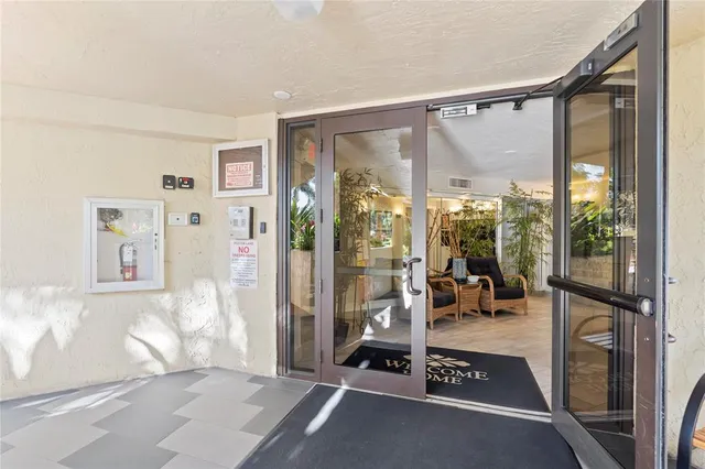a view of a livingroom with couch and floor to ceiling window