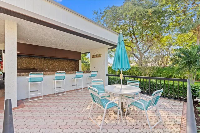 a patio with yard glass top table and chairs