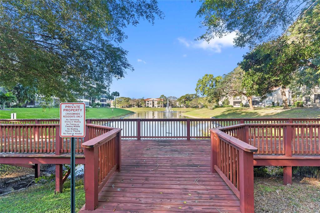 1850 Homewood Boulevard, Unit 512 Delray Beach, FL 33445 - Photo 39 of 43 a view of a deck with wooden floor and fence next to a yard