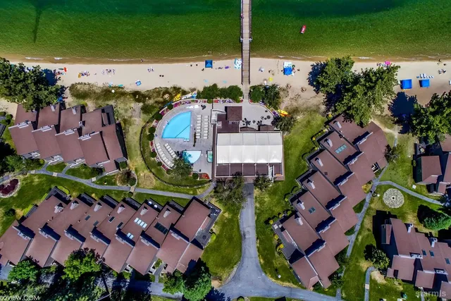 an aerial view of multiple houses with yard