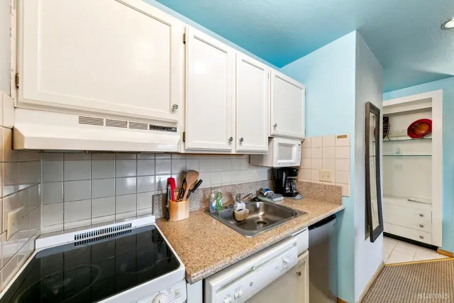 a living room with furniture and kitchen view
