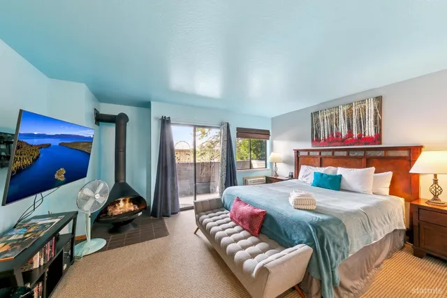 a bed room with a bed and a large window