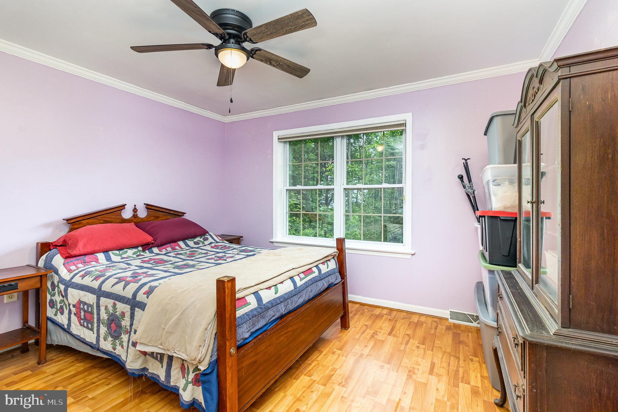 316 House Rock Road Pequea, PA 17565 - Photo 15 of 21 a bedroom with a bed a chandelier and a flat tv
