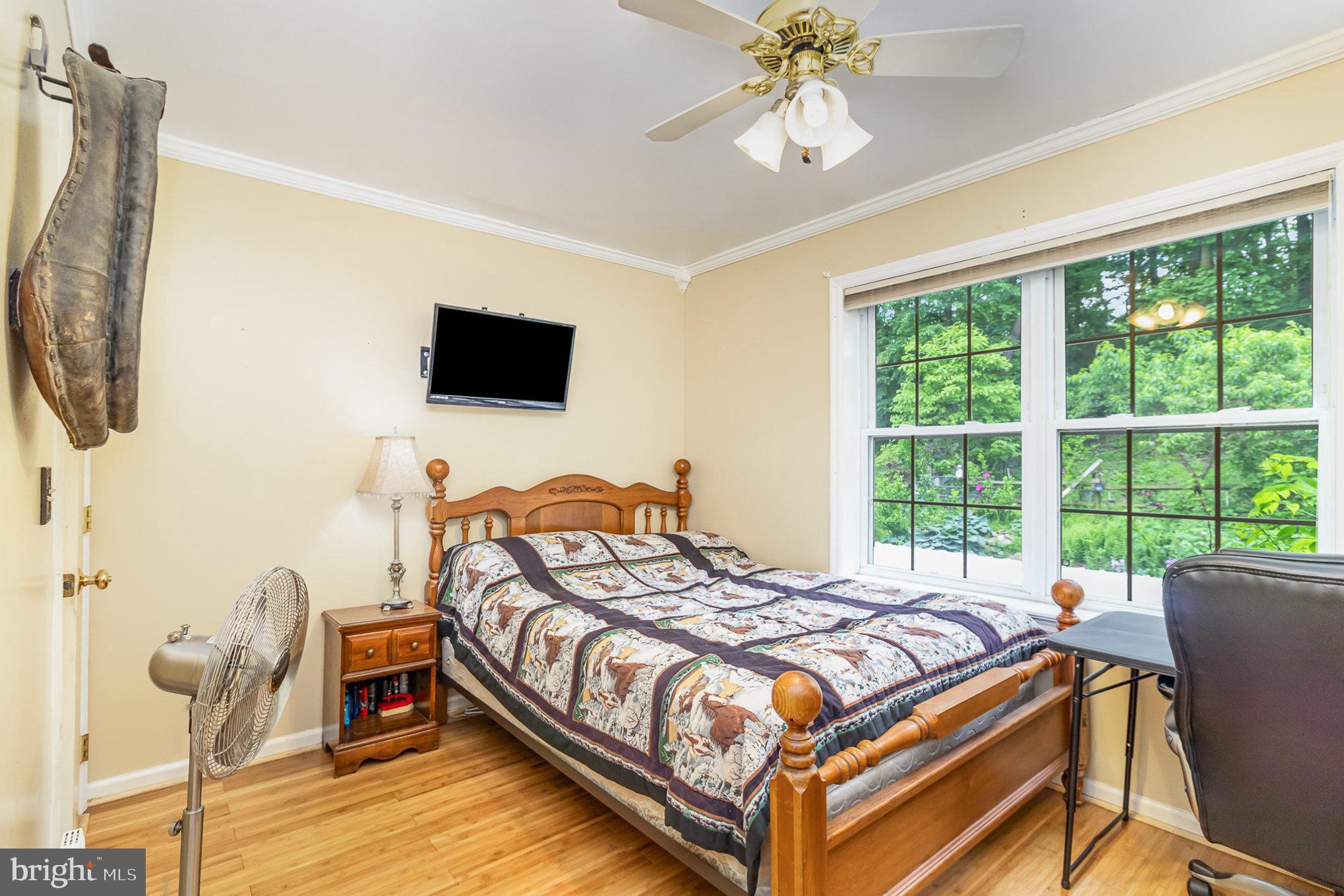 316 House Rock Road Pequea, PA 17565 - Photo 16 of 21 a bedroom with a bed and a flat tv screen next to a window