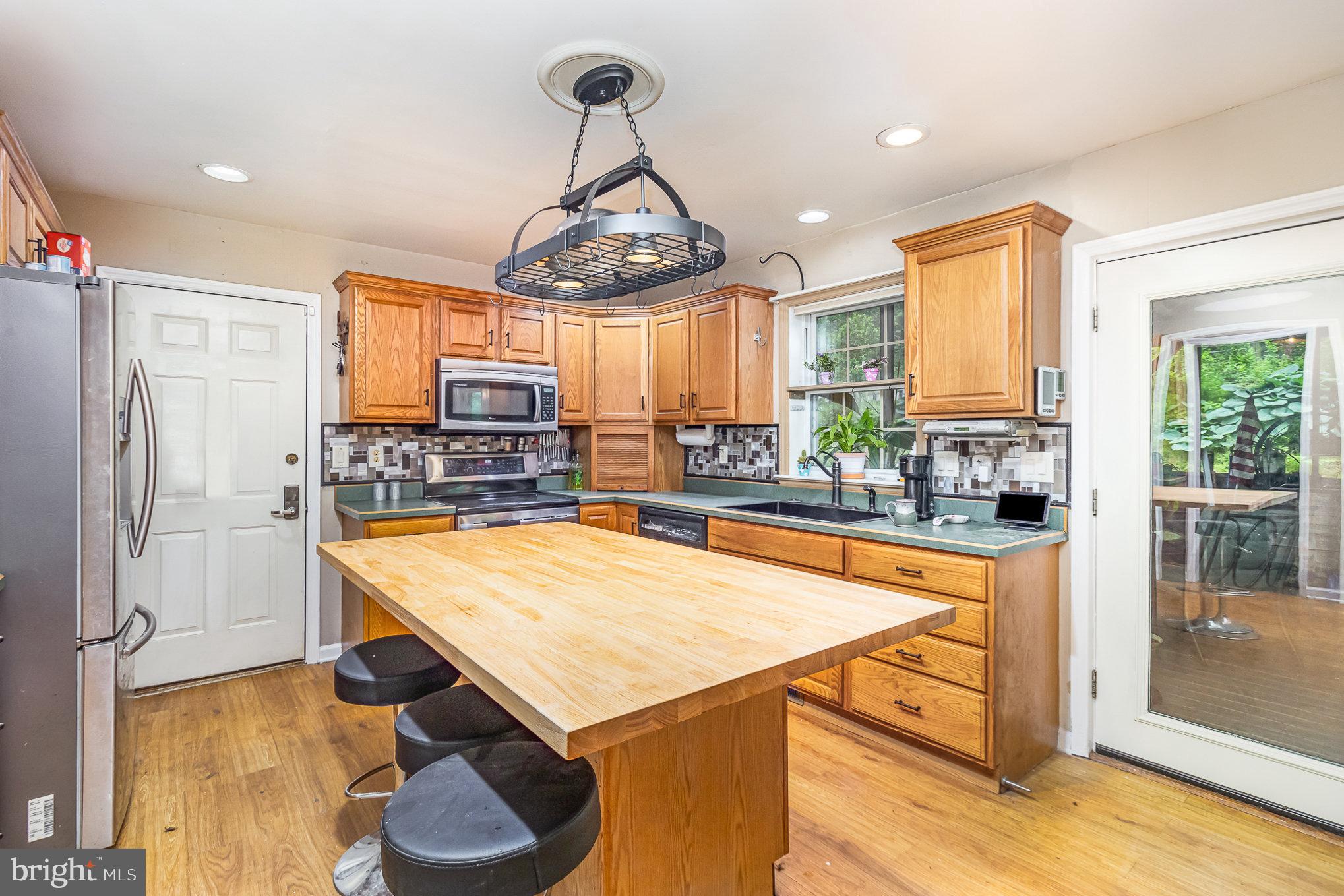 316 House Rock Road Pequea, PA 17565 - Photo 4 of 21 a room with stainless steel appliances kitchen island granite countertop furniture and a chandelier
