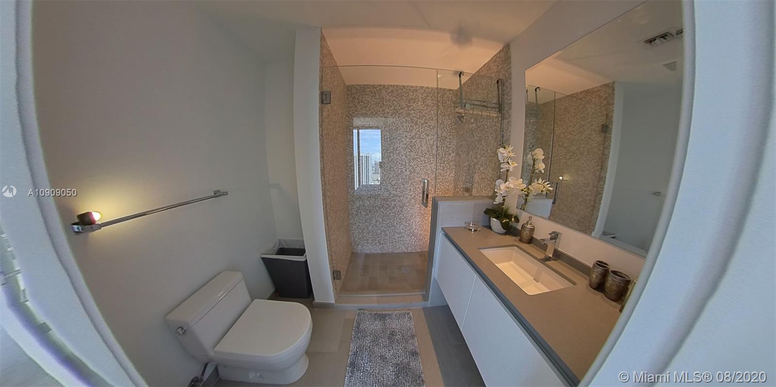 88 Southwest 7th Street, Unit 2911 Miami, FL 33130 - Photo 19 of 25 a bathroom with a double vanity sink and mirror with toilet