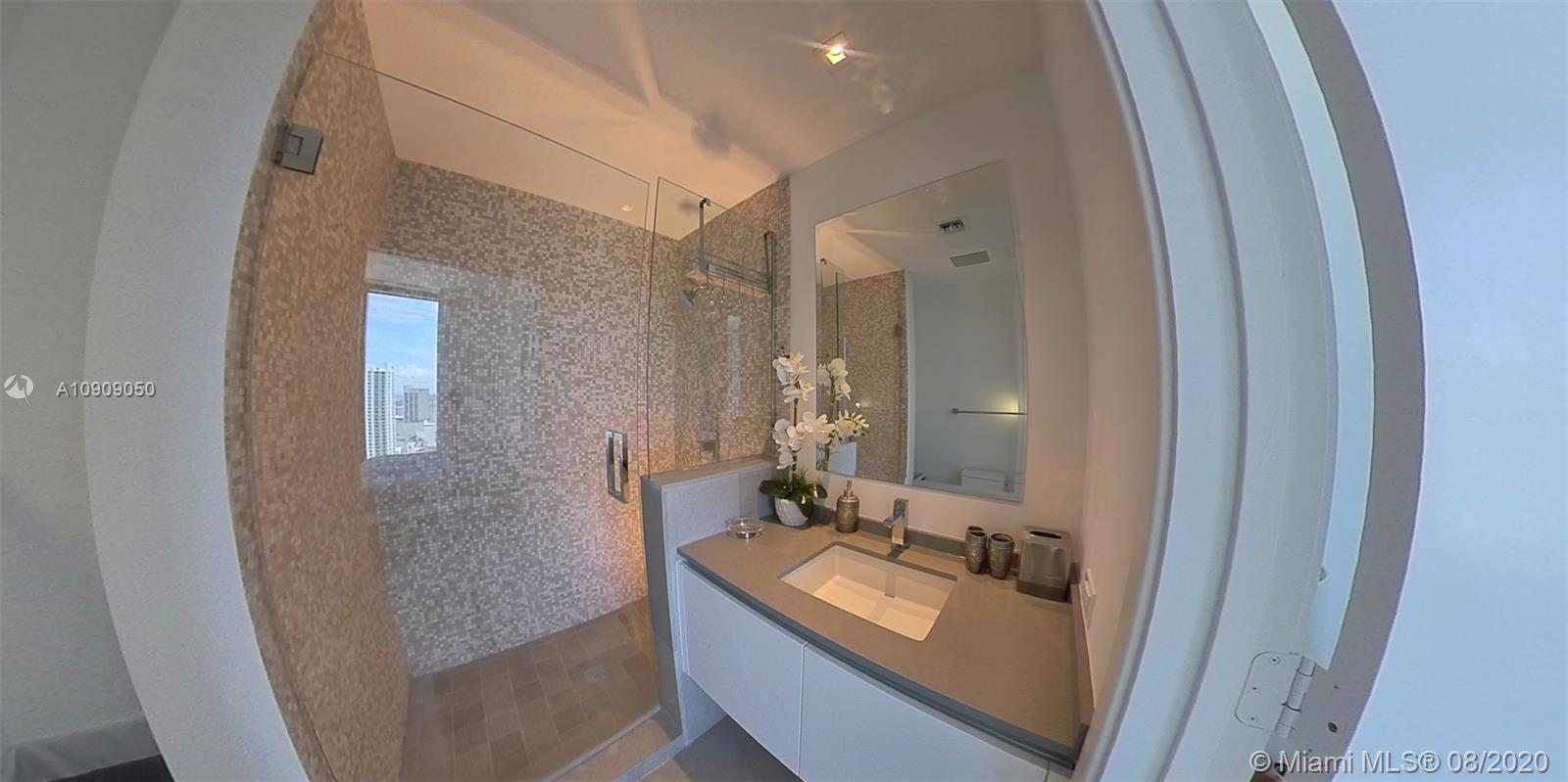 88 Southwest 7th Street, Unit 2911 Miami, FL 33130 - Photo 20 of 25 a bathroom with a double vanity sink and mirror