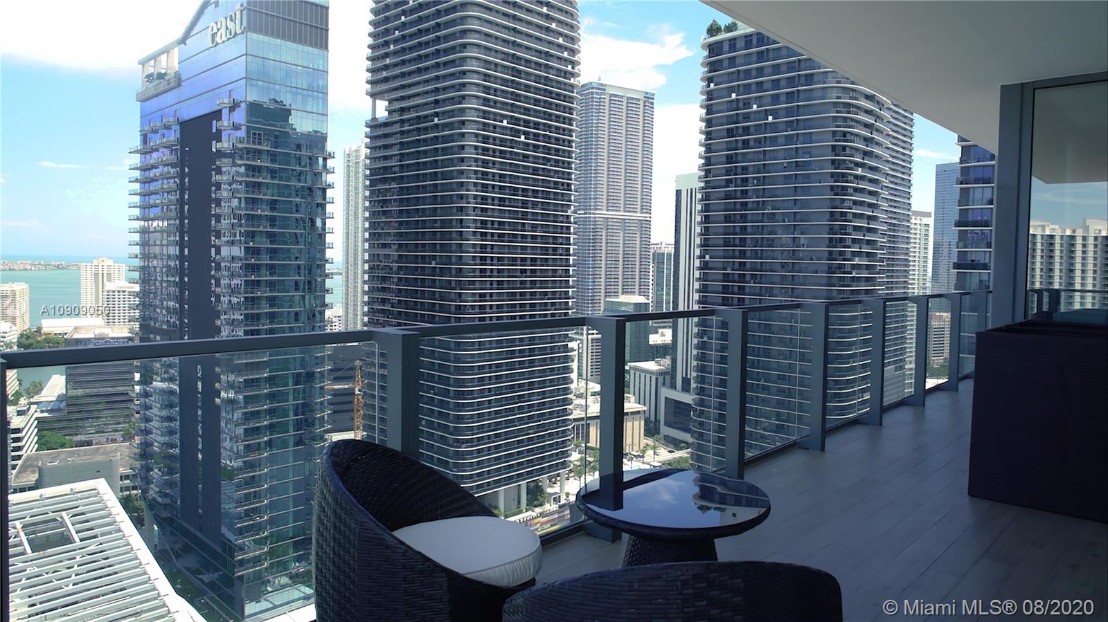 88 Southwest 7th Street, Unit 2911 Miami, FL 33130 - Photo 24 of 25 a balcony with table and chairs