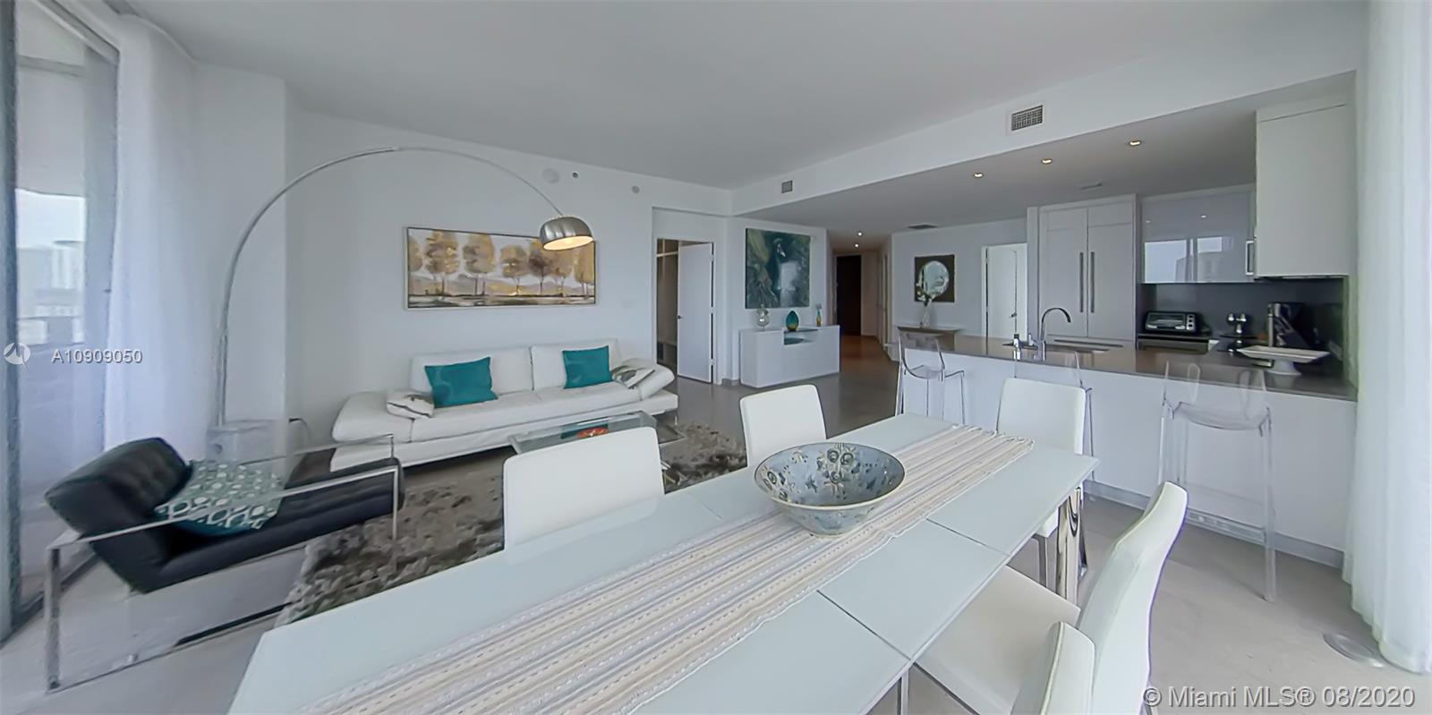 88 Southwest 7th Street, Unit 2911 Miami, FL 33130 - Photo 8 of 25 a large kitchen with a table and chairs